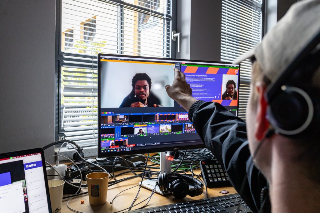 Behind the Scenes: A remote speaker is talking to the director