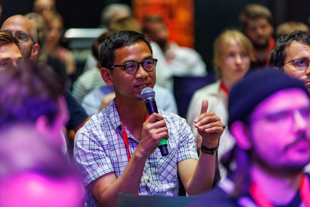 An attendee asking a question during a Q&A session