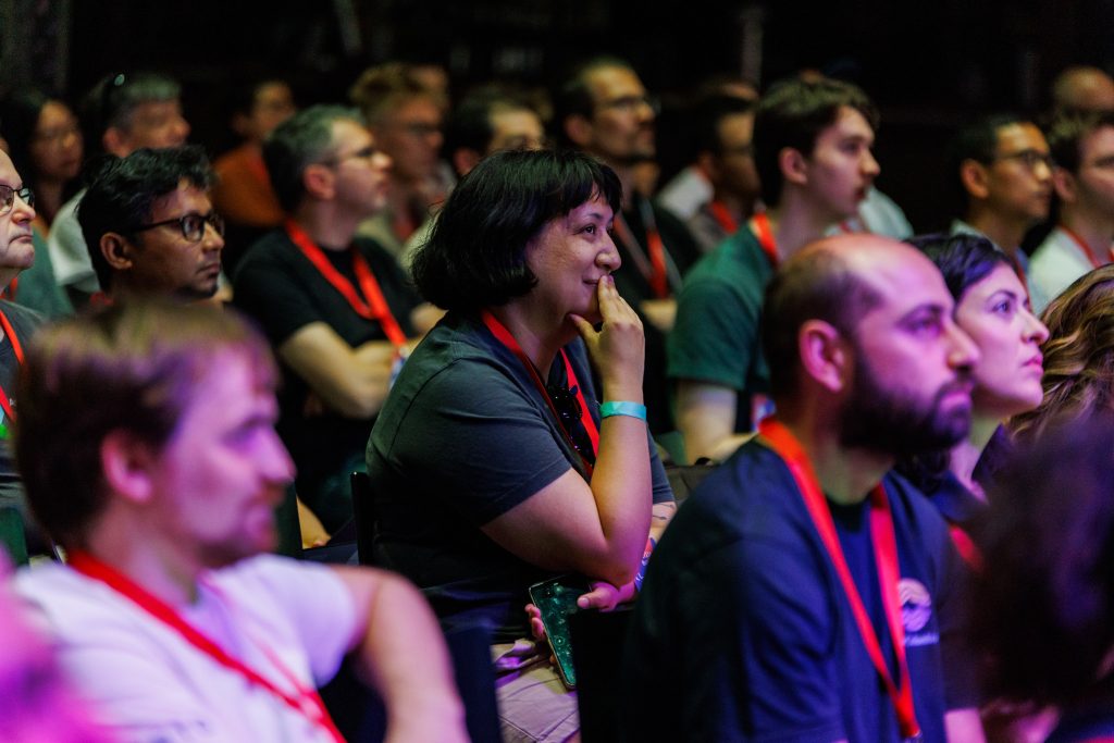 Members of the audience listening attentively to a session